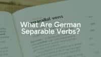 A German language textbook with the words 'trennbare Verben' highlighted, surrounded by scattered German verb prefixes like 'aus', 'ein', 'mit', educational vibe, clean and modern style.