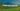 A high-speed German train racing through scenic countryside, with mountains and green fields, clear blue sky, realistic.