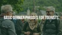 Tourist in Germany using basic German phrases, cheerful interaction with locals, scenic background with landmarks, vibrant and welcoming atmosphere, realistic.