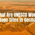 A traditional German Easter scene with colorful painted eggs hanging from blossoming branches, an Easter bunny figurine nearby, and a festive table setting with lamb-shaped cake, realistic.