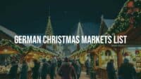 A bustling German Christmas market at night, wooden stalls with festive decorations, twinkling fairy lights, people holding mulled wine, snow-covered rooftops, cozy winter atmosphere, realistic.